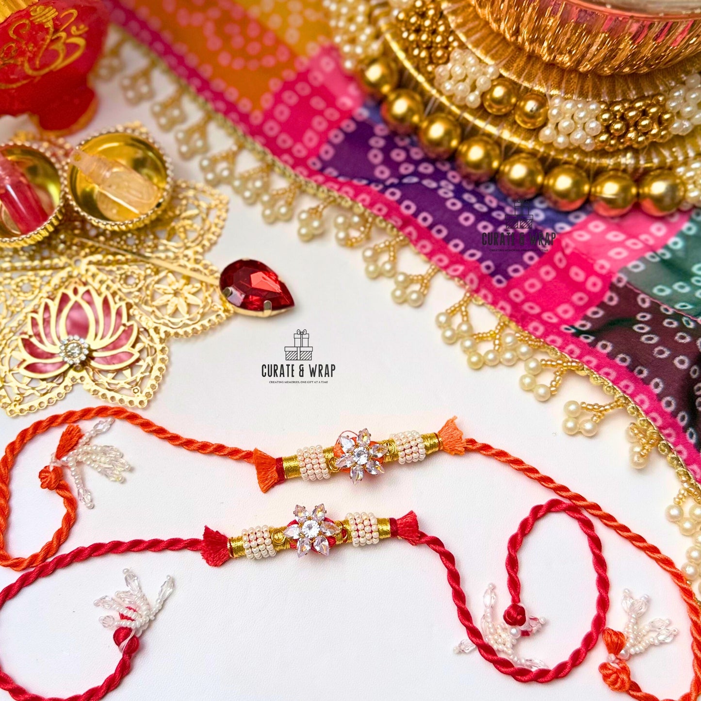 Two red and gold rakhi with decorative elements on a colorful background