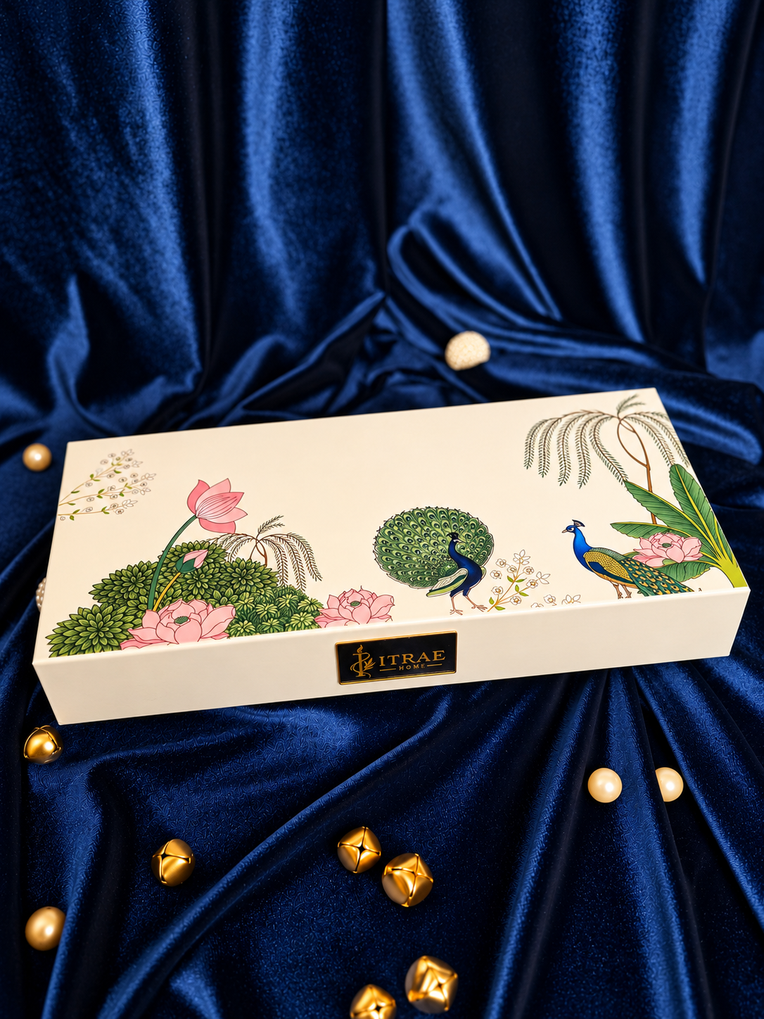 Itrae Home Padma luxury ivory candle gift box decorated with colourful peacocks, pink lotus flowers and a gold branded plaque