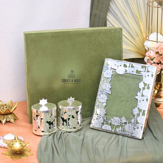 Decorative items including a photo frame, candles, and a box with 'Curate & Wrap' branding on a soft surface.