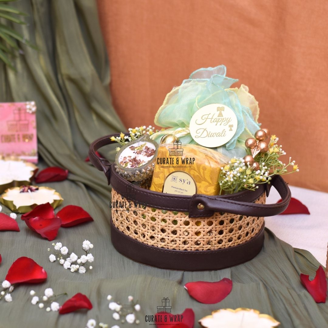 Decorative gift basket with 'Happy Diwali' message on a table with rose petals