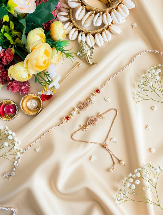 Gold and white jewelry set including a necklace, bracelet, and anklet with red and white bead accents, arranged on a beige satin fabric with decorative flowers and small bowls.