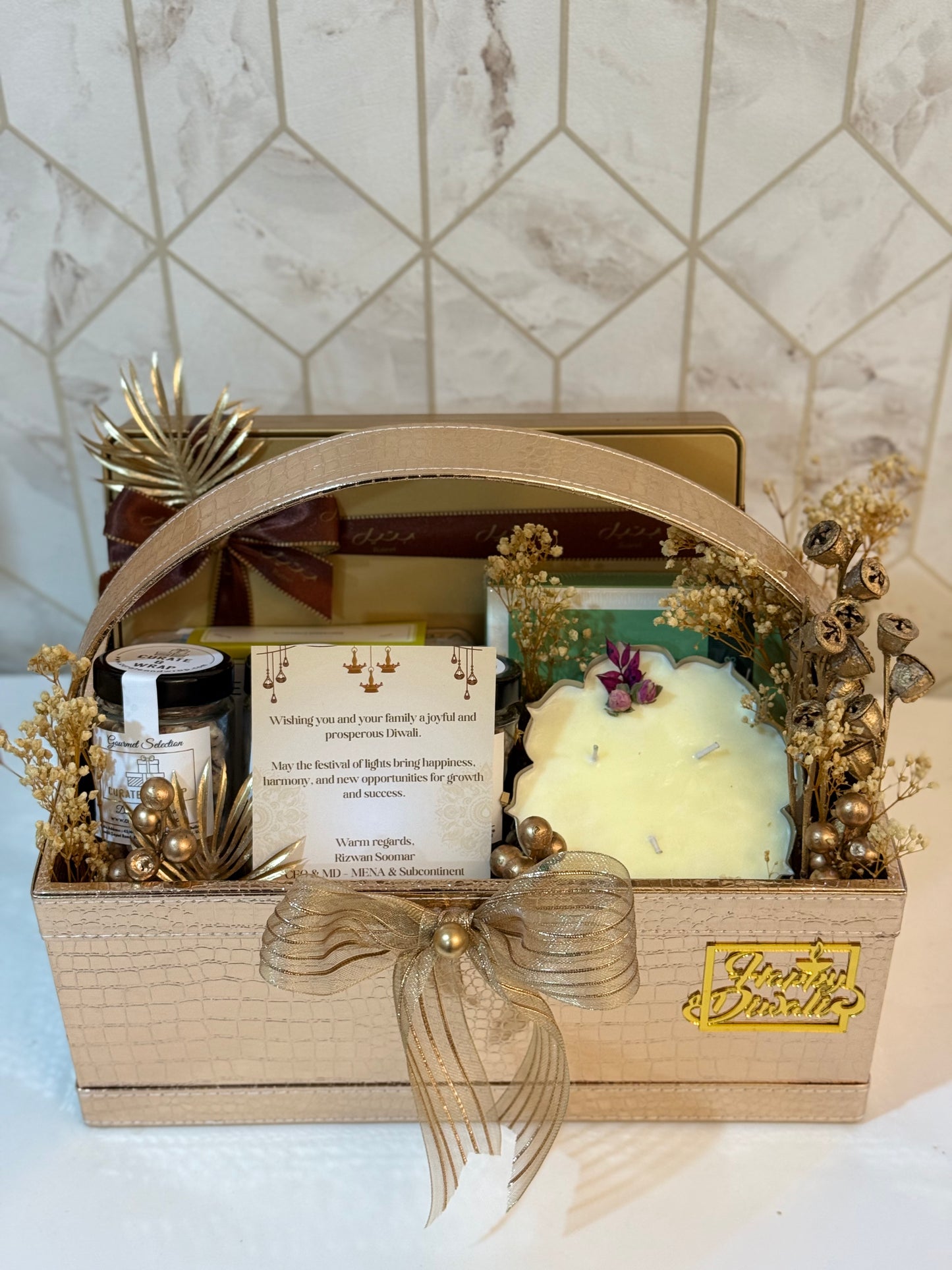 Use any variation depending on the image angle:

"Luxury Diwali gift basket with Bateel cookies and Patchi chocolates Dubai"

"Premium jumbo hamper with nuts and candle UAE"

"Festive gifting basket with assorted dry fruits and sweets Dubai"

"Corporate Diwali hamper with gourmet treats Dubai UAE"
