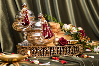 Premium Diwali gift hamper on metal mirror tray with gourmet nuts and Urli candle