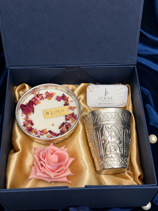 Itrae Home Silver Nakashi Set featuring an engraved silver metal glass and bowl scented candle with floral accents on a navy blue Diwali gift box