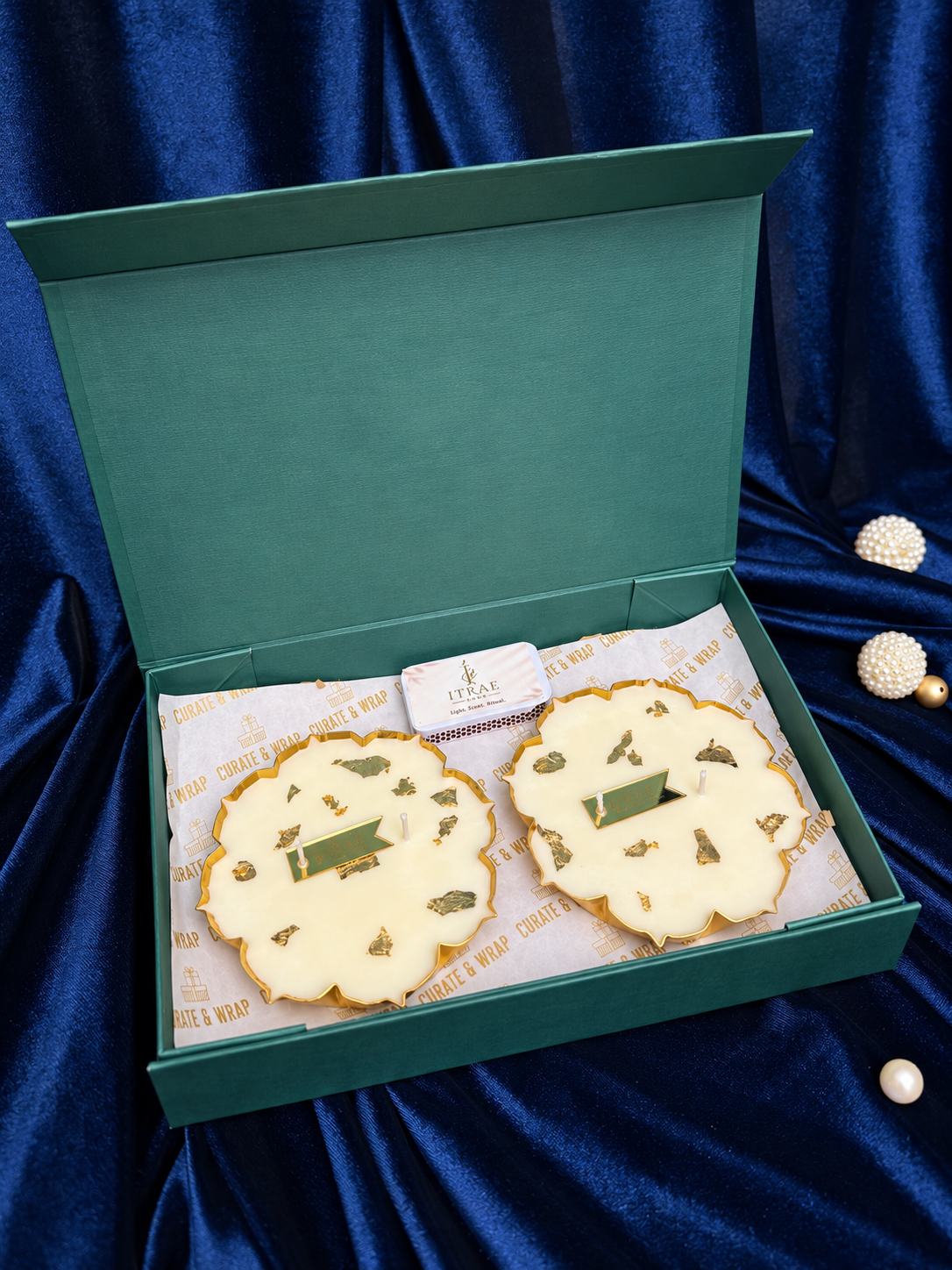 Samriddhi Box by Itrae Home featuring two gold lotus metal Urli scented candles in a premium green gift box