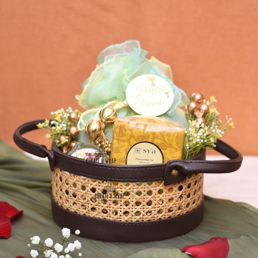 Rattan Hamper with vegan leather basket, Karak spice tea, soy wax glass diyas, and assorted nuts – Curate and Wrap Dubai