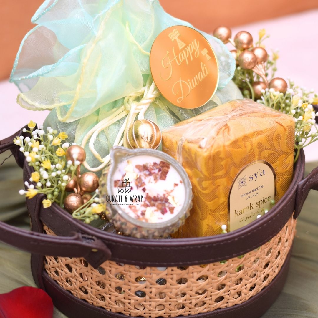 Rattan Hamper with vegan leather basket, Karak spice tea, soy wax glass diyas, and assorted nuts – Curate and Wrap Dubai